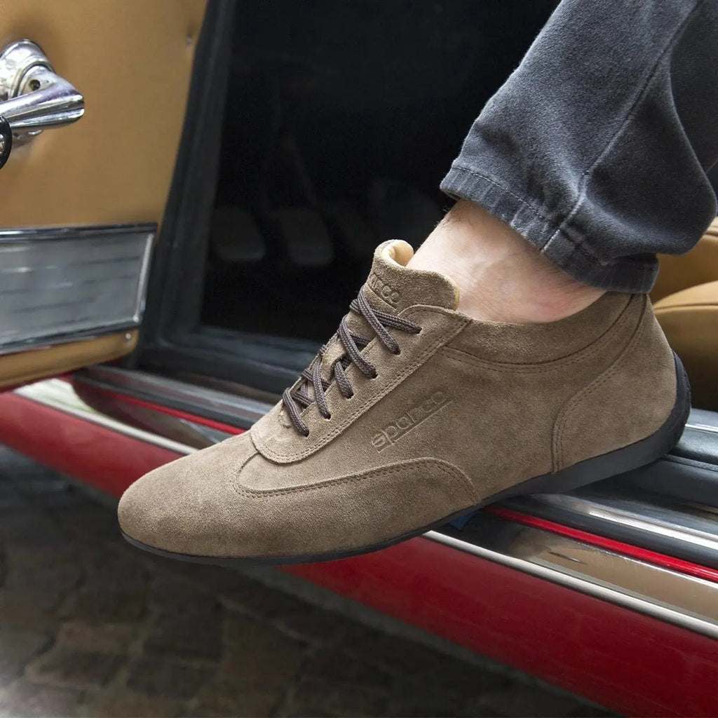 Chaussure basse Sparco Imola en cuir suédé marron taupe, portée dans une voiture